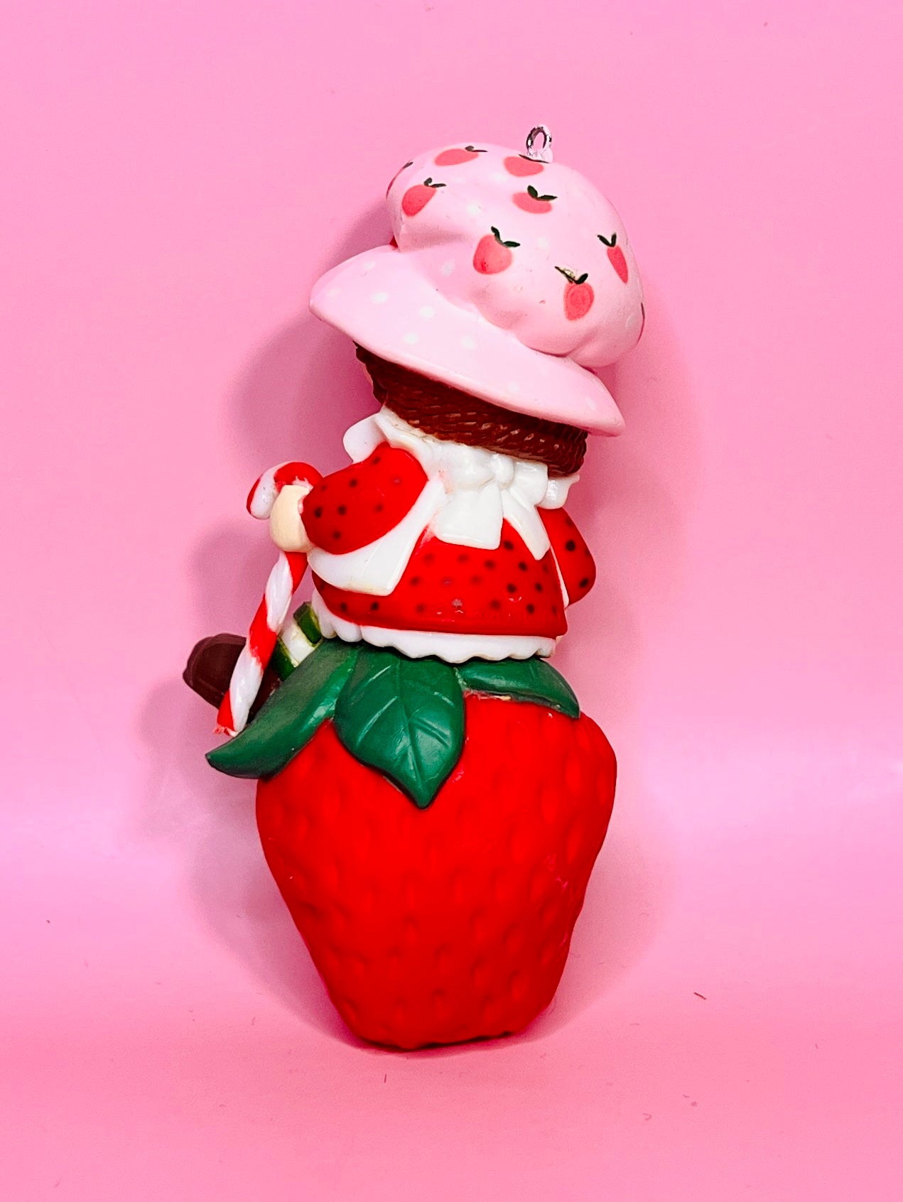1982 Vintage Strawberry Shortcake Ceramic Christmas Ornament: Strawberry Herself with Candy Cane sitting on a Strawberry!