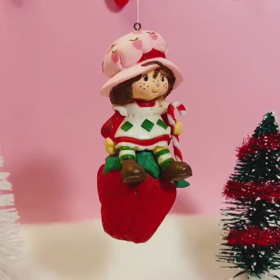 1982 Vintage Strawberry Shortcake Ceramic Christmas Ornament: Strawberry Herself with Candy Cane sitting on a Strawberry!