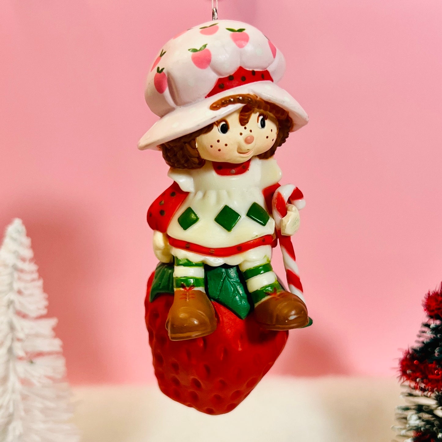 Boxed 1982 Vintage Strawberry Shortcake Ceramic Christmas Ornament: Strawberry Herself with Candy Cane sitting on a Strawberry! - Dolly Magic