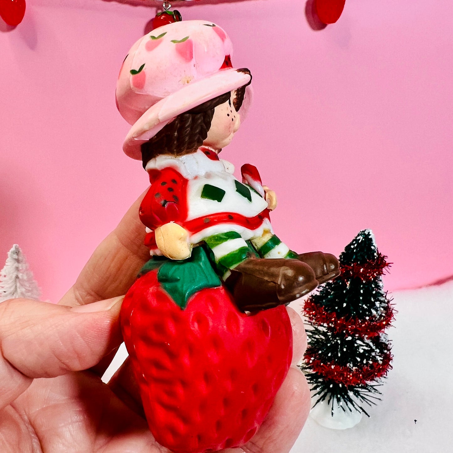 1982 Vintage Strawberry Shortcake Ceramic Christmas Ornament: Strawberry Herself with Candy Cane sitting on a Strawberry! - Dolly Magic