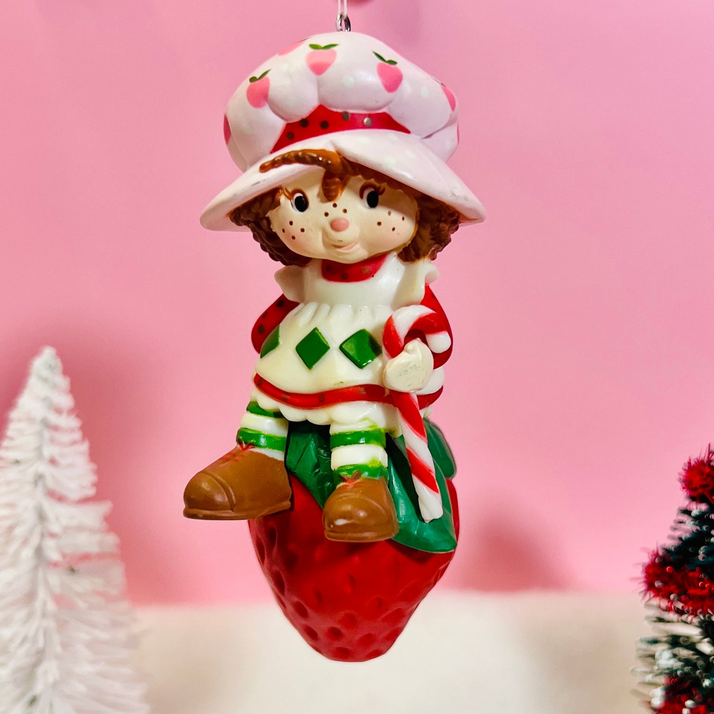 Boxed 1982 Vintage Strawberry Shortcake Ceramic Christmas Ornament: Strawberry Herself with Candy Cane sitting on a Strawberry! - Dolly Magic