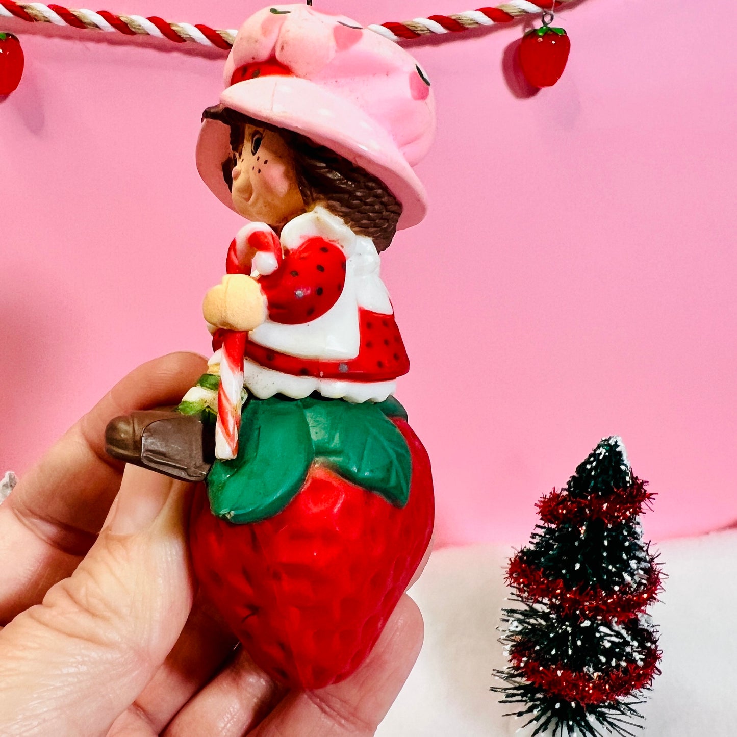1982 Vintage Strawberry Shortcake Ceramic Christmas Ornament: Strawberry Herself with Candy Cane sitting on a Strawberry! - Dolly Magic