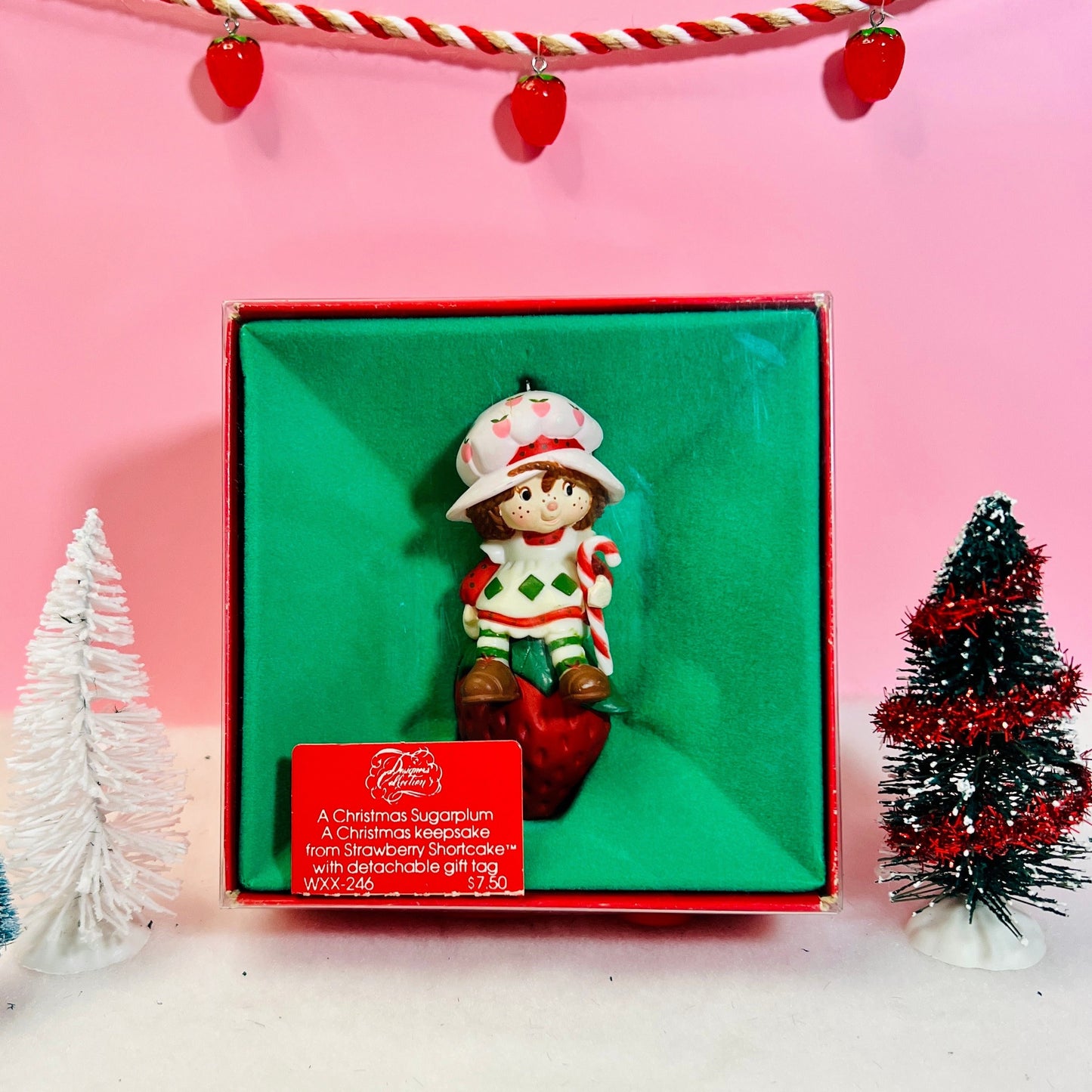 Boxed 1982 Vintage Strawberry Shortcake Ceramic Christmas Ornament: Strawberry Herself with Candy Cane sitting on a Strawberry! - Dolly Magic